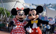 Mickey and Minnie are at a character greeting spot inside EPCOT theme park.