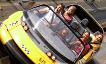 A family has fun on the Test Track ride at EPCOT theme park located in Orlando.